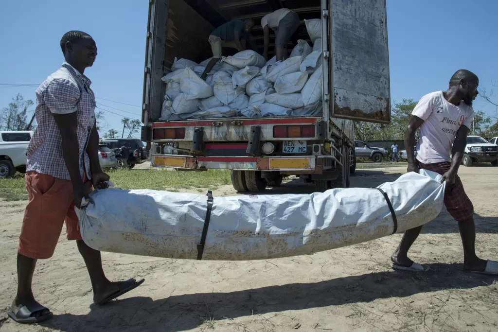 Emergency shelter kits are unloaded from a truck near Beira, Mozambique, following Cyclone Idai. 